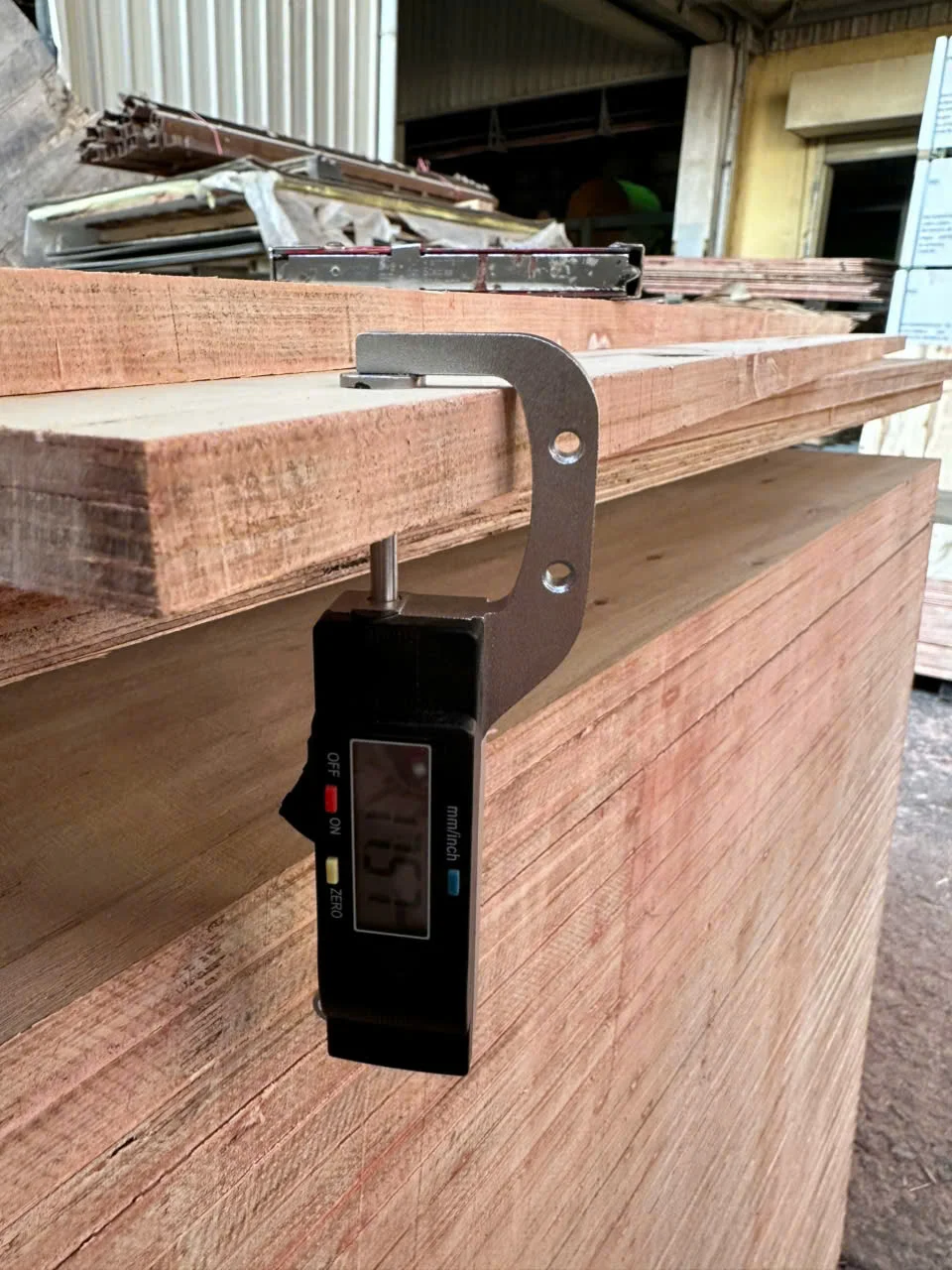 Vietnam plywood QC thickness measurement — calibrated caliper check before packing at Mika Plywood factory