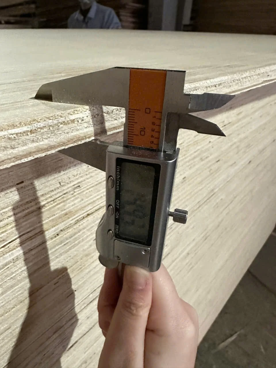 QC thickness measurement with caliper at Mika Plywood plywood factory